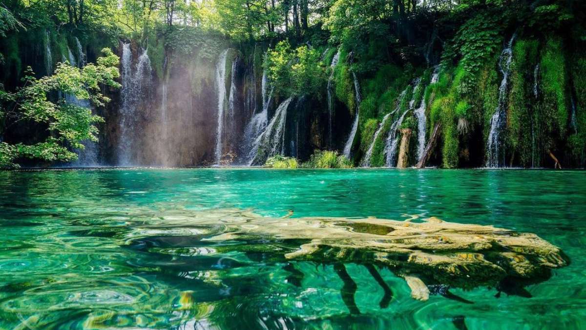 Waterfall with clear blue water.